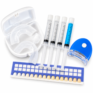 Teeth whitening kit with four gel syringes, blue LED mouth light, clear mouth trays and a tooth shade guide