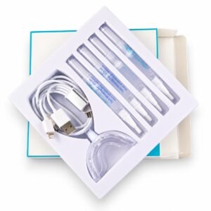 Open white tray kit containing four whitening pens, an LED mouth tray and a multi-adapter USB cable